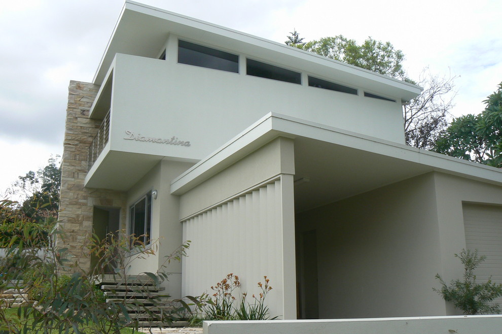 Design ideas for a contemporary two-storey exterior in Sydney with mixed siding.