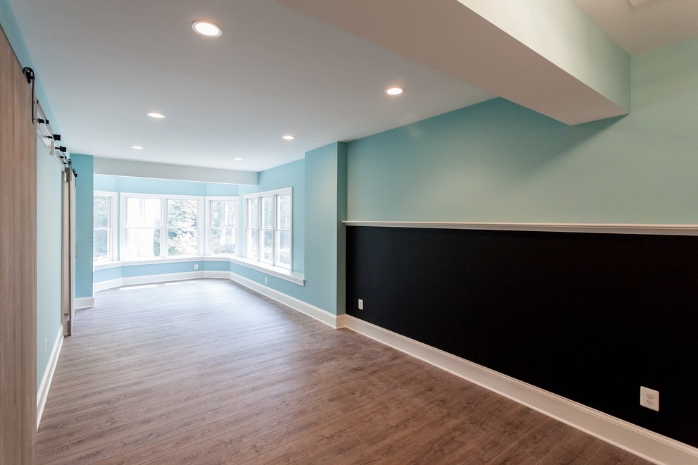 Photo of a traditional kids' playroom in DC Metro with blue walls and brown floor.