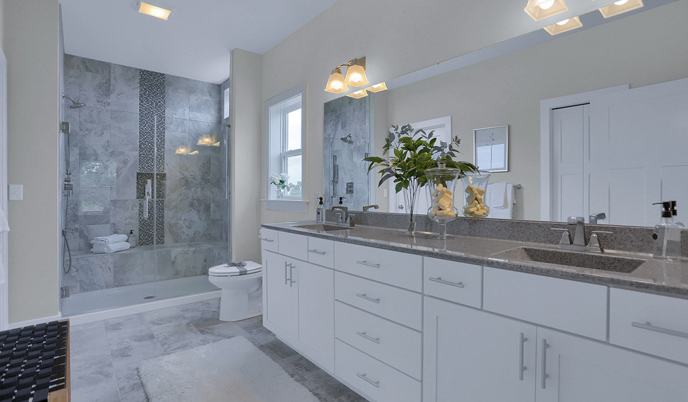 Design ideas for a large traditional master bathroom in Other with shaker cabinets, grey cabinets, an alcove shower, grey walls, ceramic floors, an integrated sink, granite benchtops, grey floor, a hinged shower door and grey benchtops.