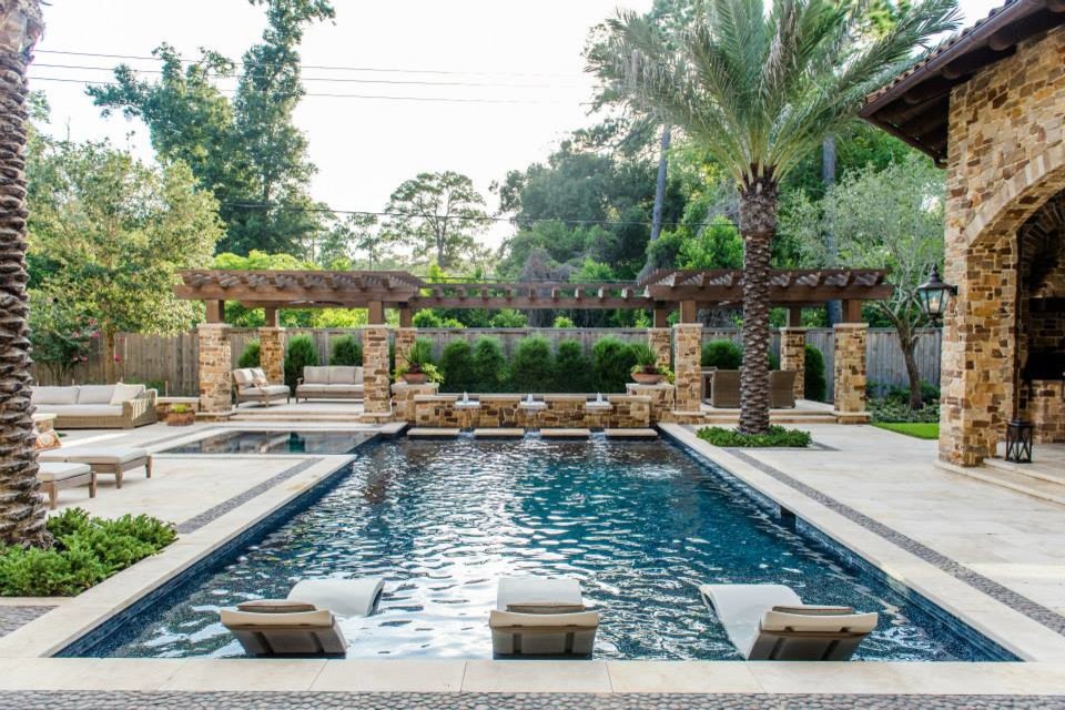 Photo of a large mediterranean backyard rectangular lap pool in Houston with a hot tub and tile.