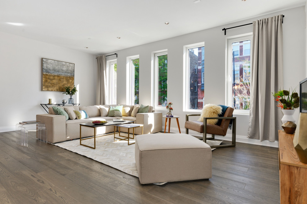 Contemporary open concept living room in Chicago with white walls, medium hardwood floors, no fireplace, a freestanding tv and brown floor.