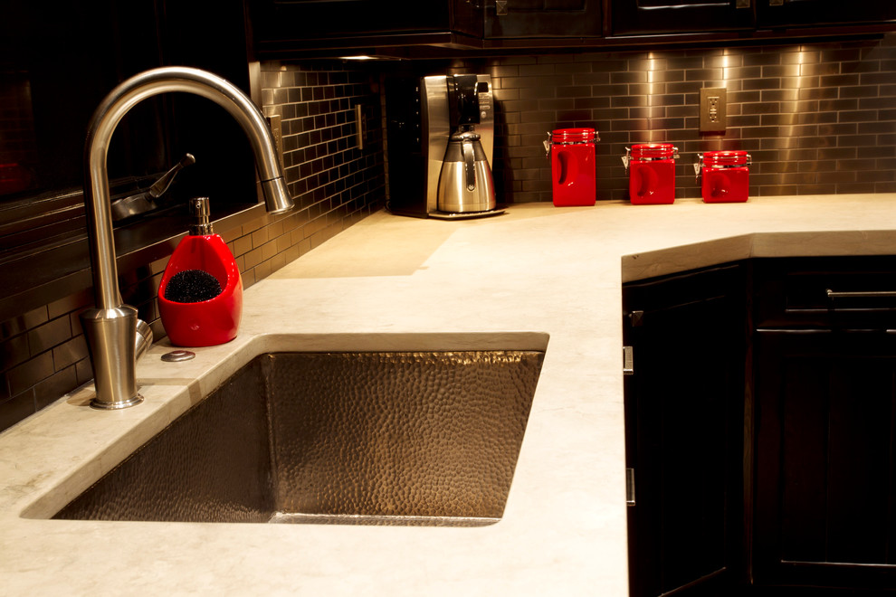 Example of a mountain style open concept kitchen design with an undermount sink and an island