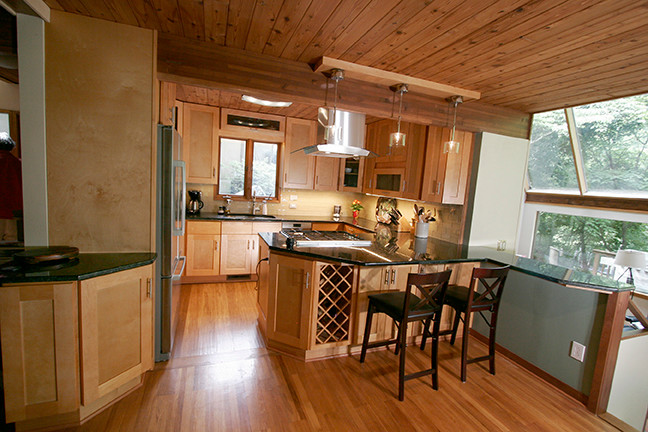 Small transitional l-shaped porcelain tile eat-in kitchen photo with shaker cabinets, light wood cabinets, granite countertops, beige backsplash, glass tile backsplash, stainless steel appliances and a peninsula