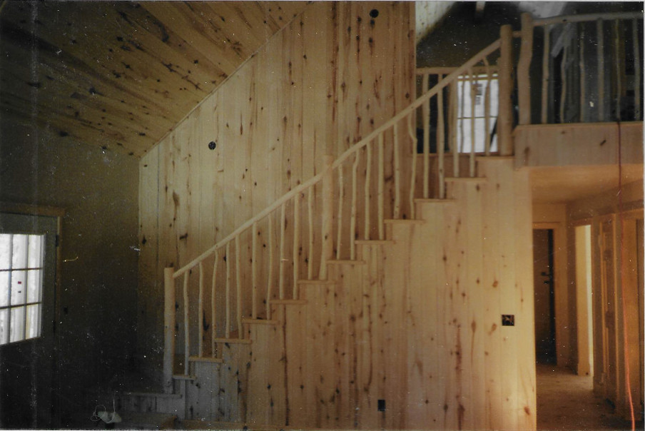 Staircase - mid-sized rustic wooden straight wood railing staircase idea in Albuquerque with wooden risers