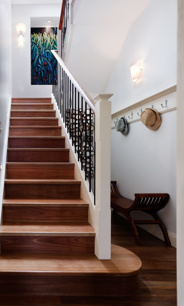 This is an example of a mid-sized contemporary wood u-shaped staircase in Sydney with wood risers.