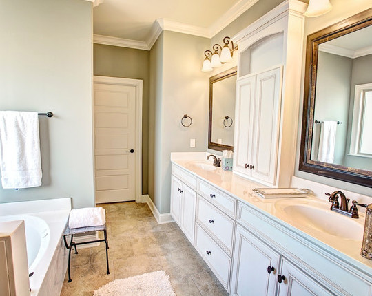 Small traditional master bathroom in Birmingham with an undermount sink, beaded inset cabinets, white cabinets, solid surface benchtops, an alcove tub, a corner shower, a two-piece toilet, white tile, porcelain tile, green walls and porcelain floors.