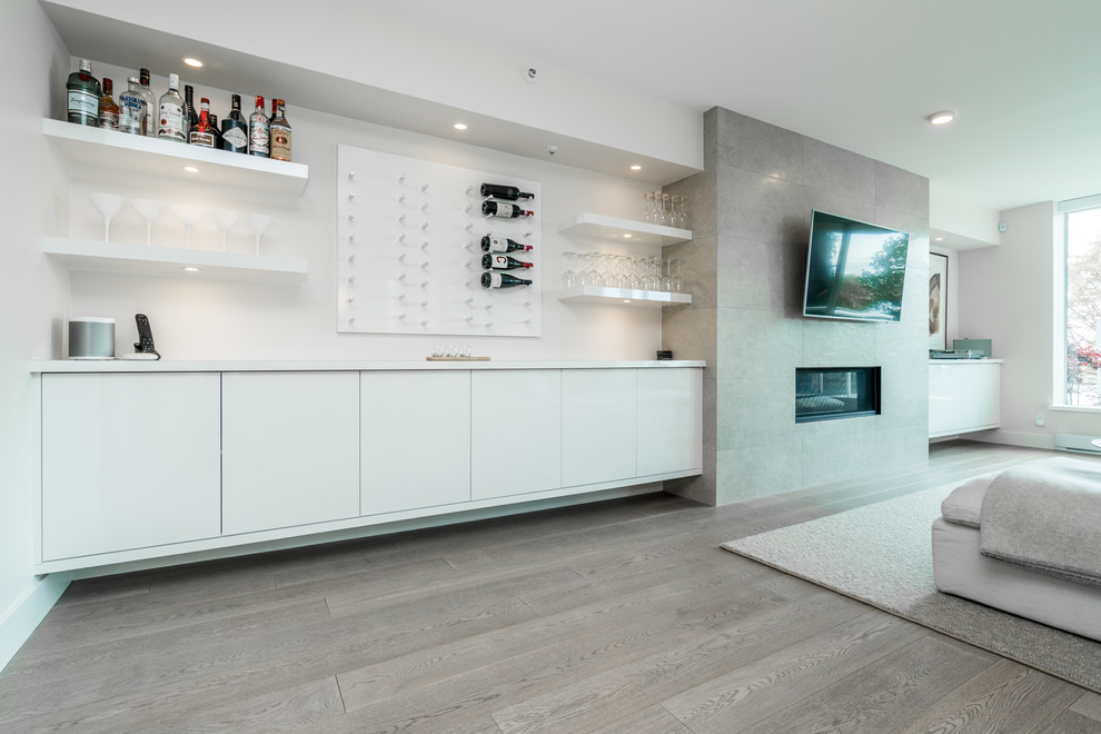 Mid-sized contemporary single-wall bar cart in Vancouver with flat-panel cabinets, white cabinets, wood benchtops, white splashback, medium hardwood floors, grey floor and white benchtop.