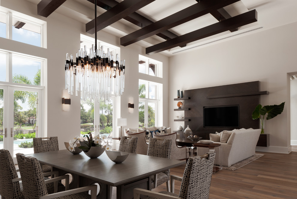 This is an example of a large transitional open concept family room in Miami with grey walls, medium hardwood floors, no fireplace and a built-in media wall.