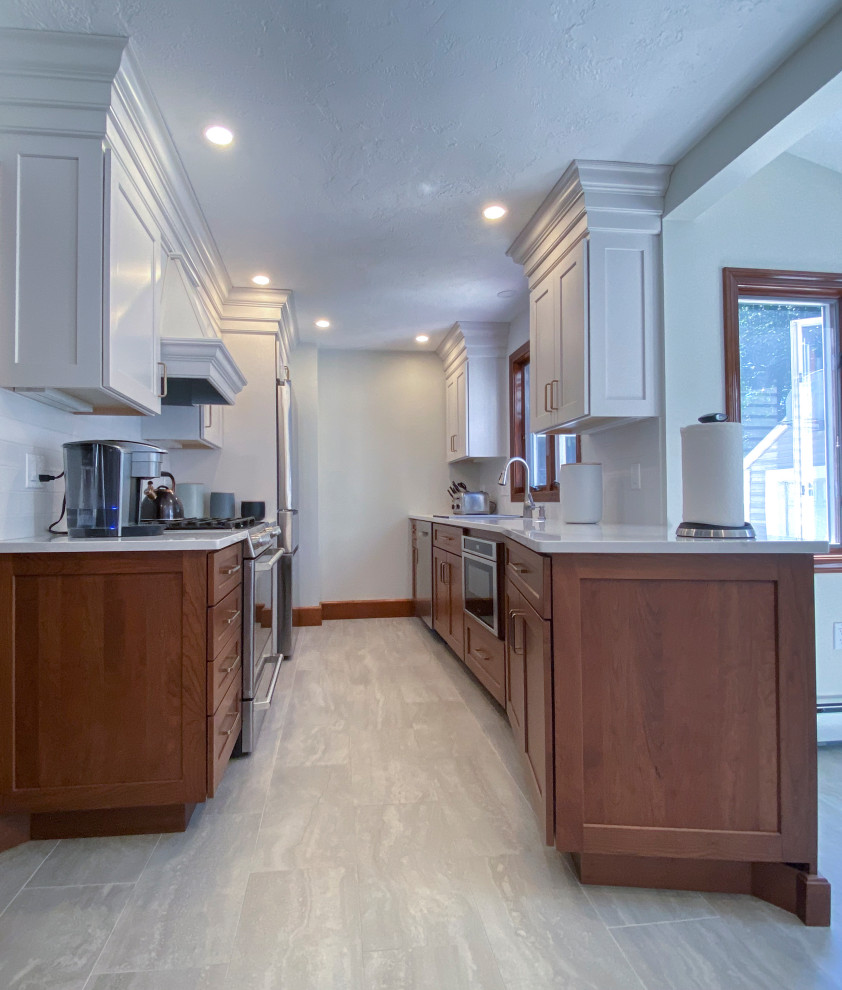 Small transitional galley eat-in kitchen photo in Boston with a drop-in sink, shaker cabinets, white cabinets, quartzite countertops, white backsplash, glass tile backsplash, stainless steel appliances, no island and white countertops