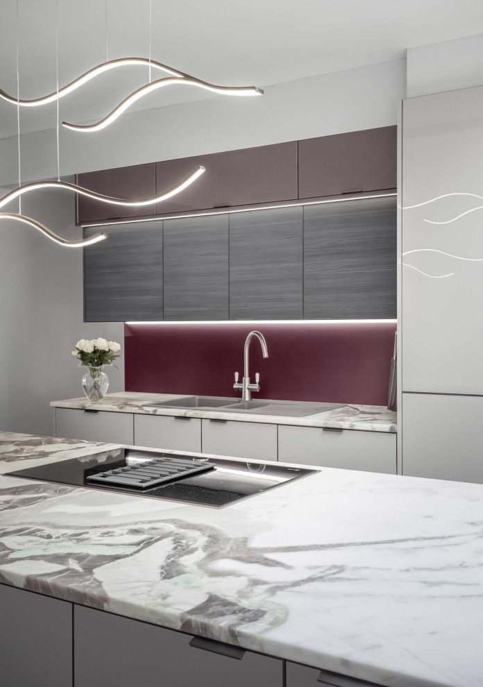Inspiration for a large contemporary grey and purple single-wall kitchen in Other with flat-panel cabinets, beige cabinets, quartz worktops, glass sheet splashback, black appliances, ceramic flooring, an island, multi-coloured floors, multicoloured worktops and feature lighting.