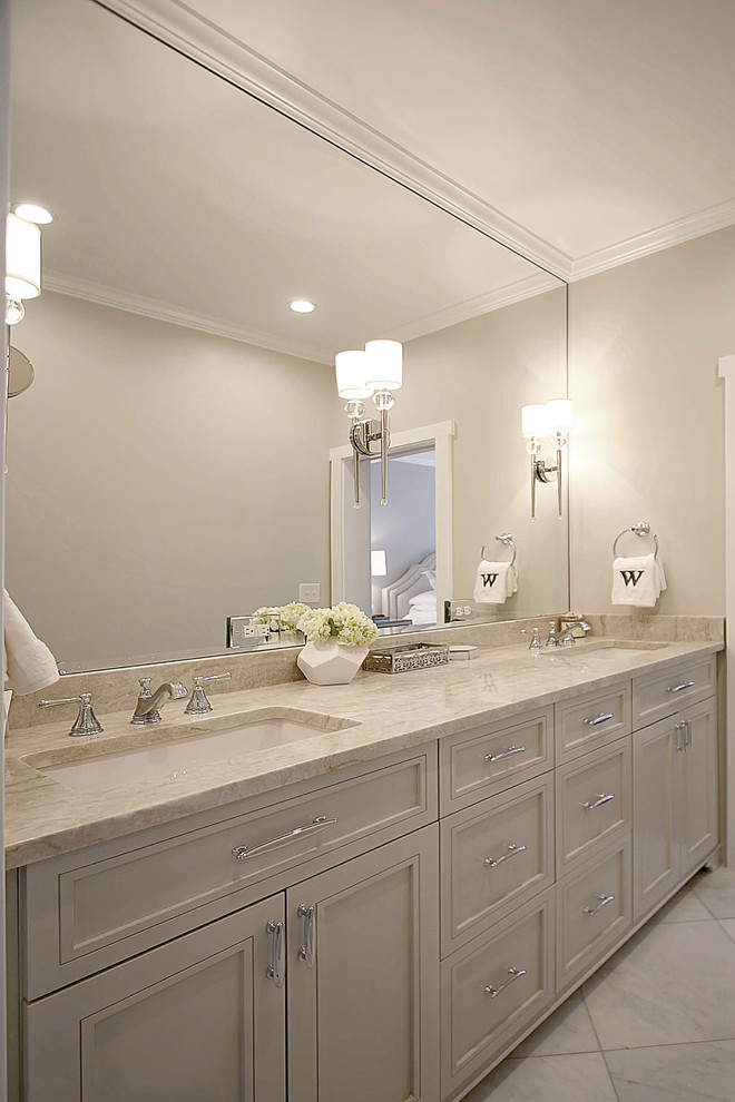 Inspiration for a small transitional master bathroom in Charlotte with flat-panel cabinets, beige cabinets, a freestanding tub, beige tile, marble, marble floors and engineered quartz benchtops.