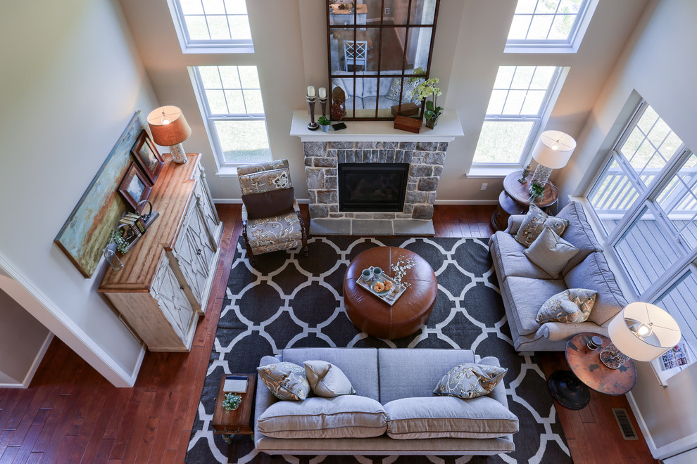 Example of a large transitional open concept medium tone wood floor and brown floor home design design with beige walls, a standard fireplace, a stone fireplace and no tv
