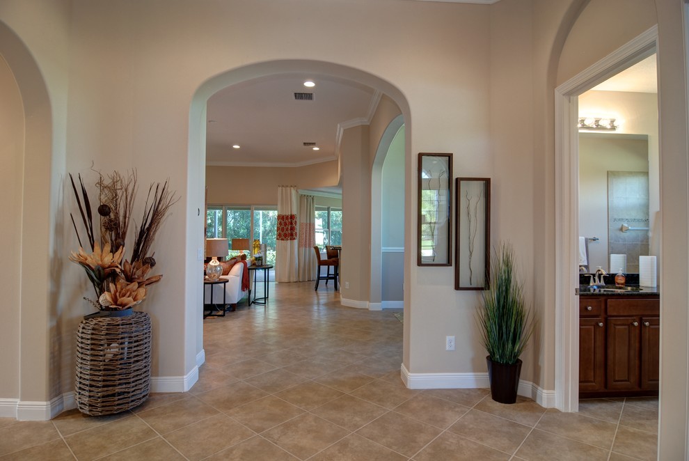 Photo of a contemporary entryway in Miami with beige walls and ceramic floors.