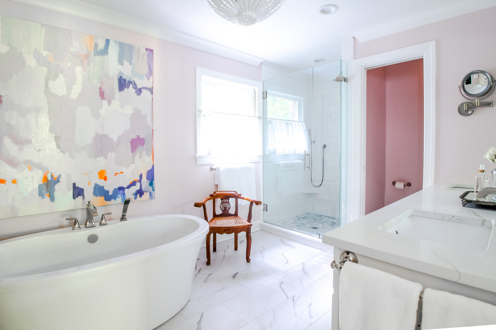 This is an example of a mid-sized eclectic master bathroom in Charlotte with shaker cabinets, white cabinets, a freestanding tub, a corner shower, white tile, ceramic tile, pink walls, an undermount sink, engineered quartz benchtops, a hinged shower door, white benchtops, a double vanity and a freestanding vanity.