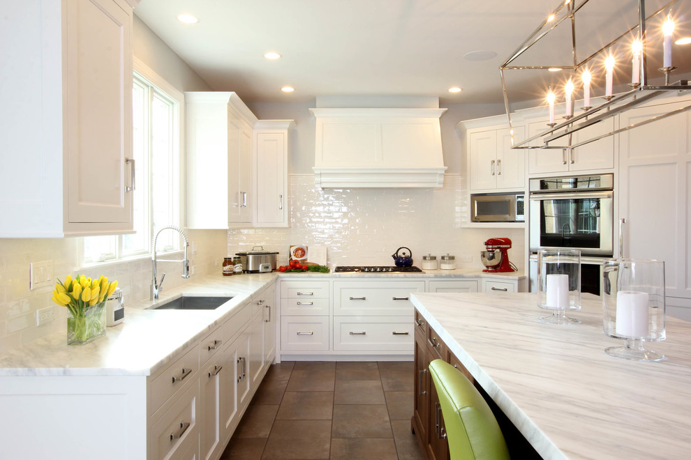 Photo of a mid-sized transitional u-shaped eat-in kitchen in Philadelphia with an undermount sink, beaded inset cabinets, white cabinets, marble benchtops, white splashback, ceramic splashback, stainless steel appliances and porcelain floors.