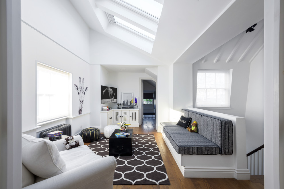 Photo of a mid-sized contemporary gender-neutral kids' playroom for kids 4-10 years old in London with white walls, medium hardwood floors and brown floor.