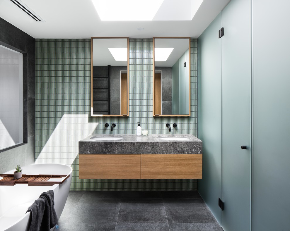 Design ideas for a mid-sized contemporary master bathroom in Melbourne with flat-panel cabinets, white cabinets, a drop-in tub, a corner shower, a two-piece toilet, black and white tile, gray tile, ceramic tile, grey walls, ceramic floors, a drop-in sink, engineered quartz benchtops, grey floor, a hinged shower door and white benchtops.
