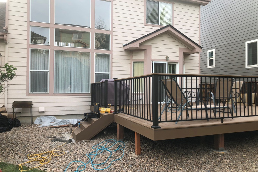 Mid-sized backyard second story mixed material railing deck photo with no cover