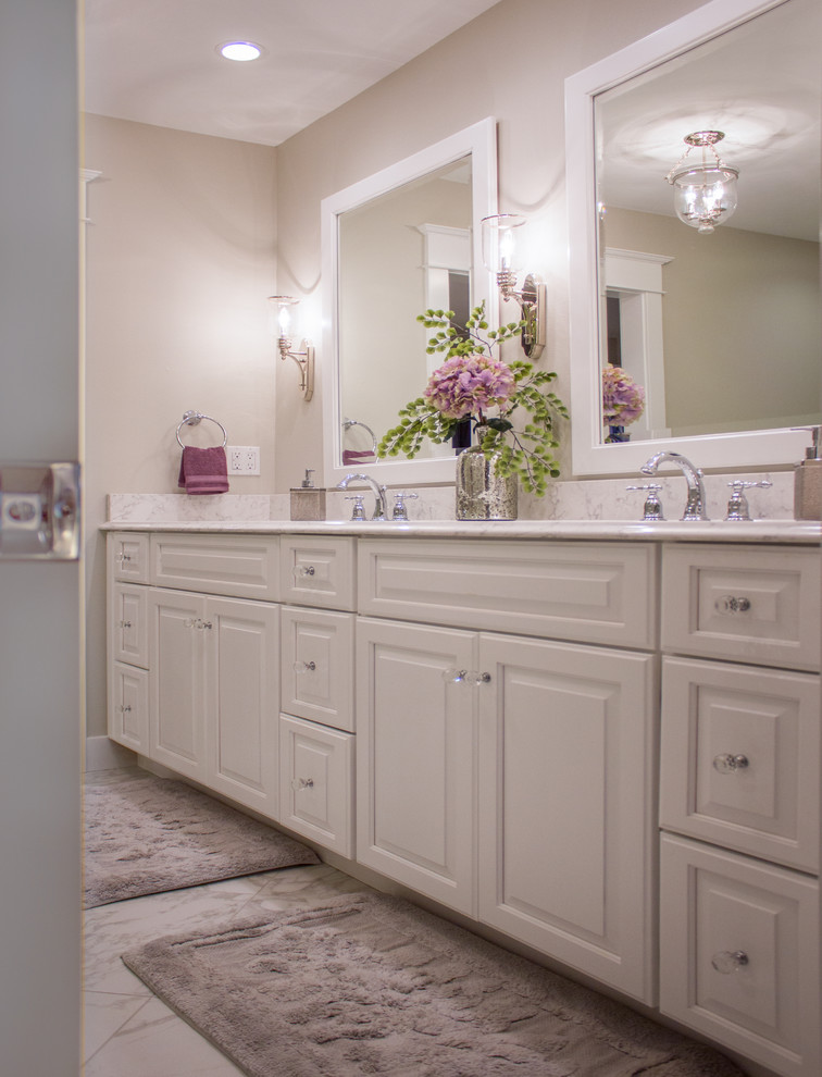 Transitional master porcelain tile bathroom photo in Cedar Rapids with recessed-panel cabinets, white cabinets, quartz countertops and beige walls