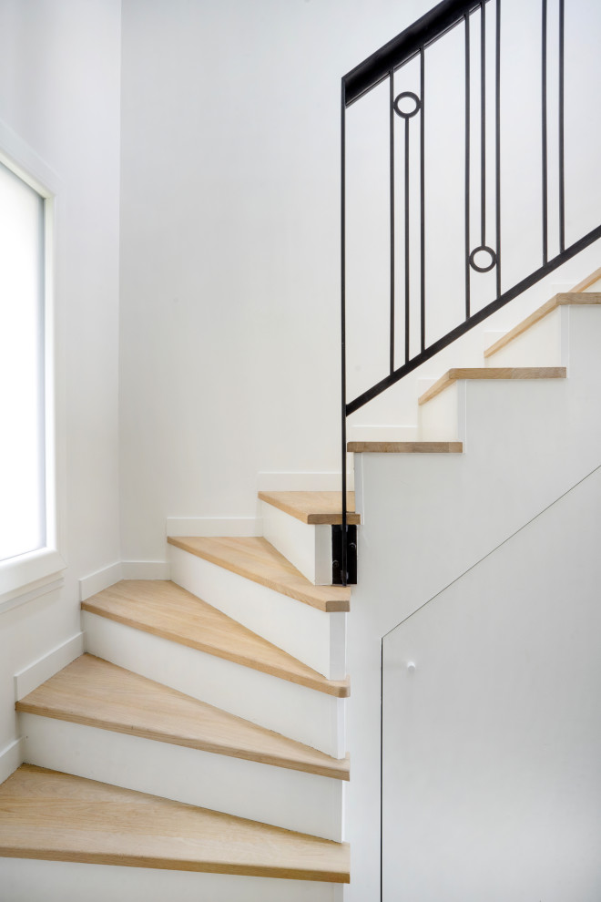 Inspiration for a contemporary wooden curved metal railing staircase remodel in Other