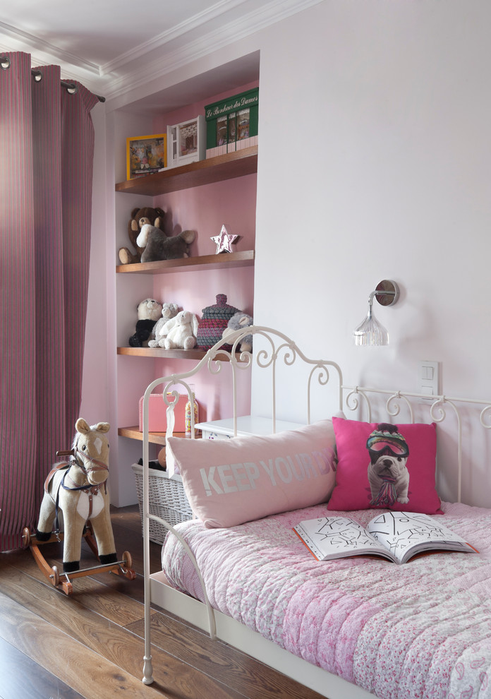 Design ideas for a mid-sized contemporary kids' bedroom for kids 4-10 years old and girls in Paris with medium hardwood floors and multi-coloured walls.