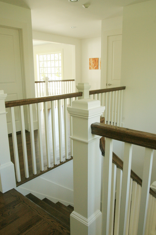 Mid-sized traditional wood u-shaped staircase in Other.