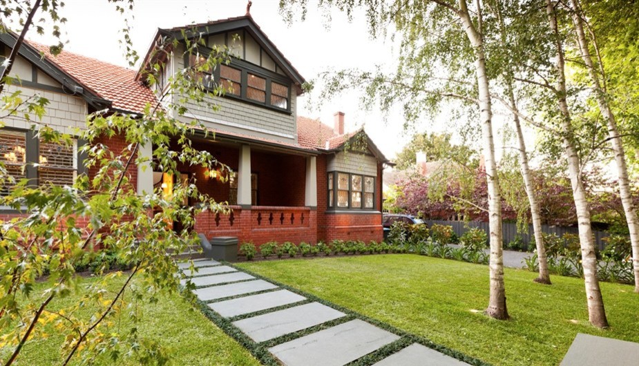 Design ideas for a contemporary front yard full sun formal garden in Melbourne with natural stone pavers.