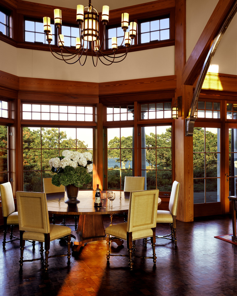 Inspiration for a large traditional dining room in Boston with no fireplace, beige walls and brown floor.