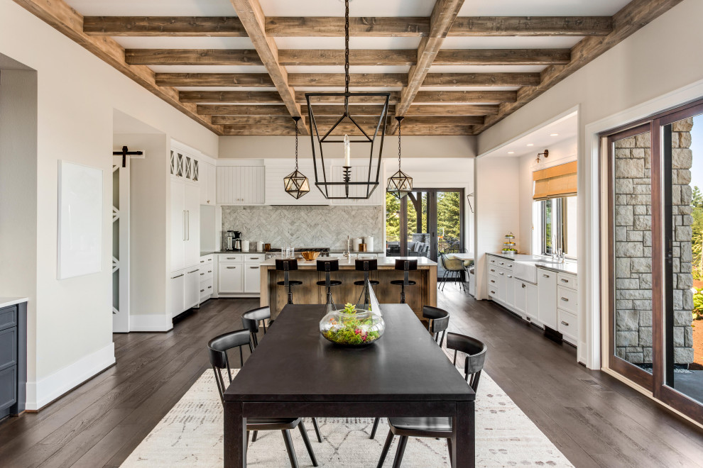 Inspiration for a country open plan dining in New York with beige walls, dark hardwood floors, brown floor and exposed beam.