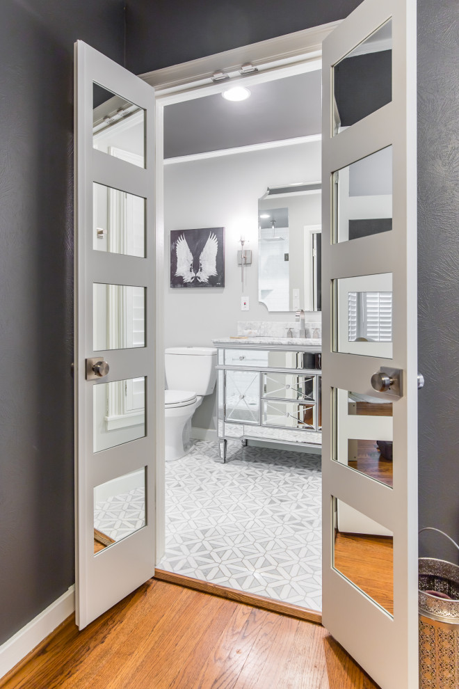 This is an example of a mid-sized contemporary master bathroom in Other with marble benchtops, grey floor, white benchtops, a single vanity, glass-front cabinets, grey cabinets, grey walls, cement tiles, an undermount sink and a freestanding vanity.