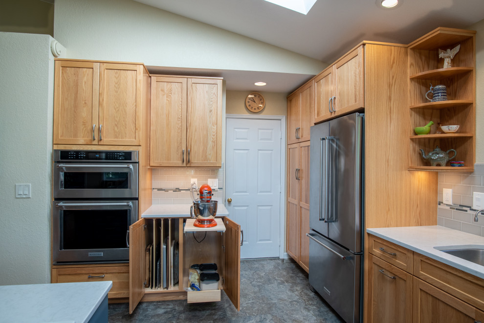 Inspiration for a mid-sized transitional l-shaped vinyl floor, blue floor and vaulted ceiling open concept kitchen remodel in Seattle with an undermount sink, recessed-panel cabinets, blue cabinets, quartz countertops, blue backsplash, ceramic backsplash, stainless steel appliances, an island and gray countertops