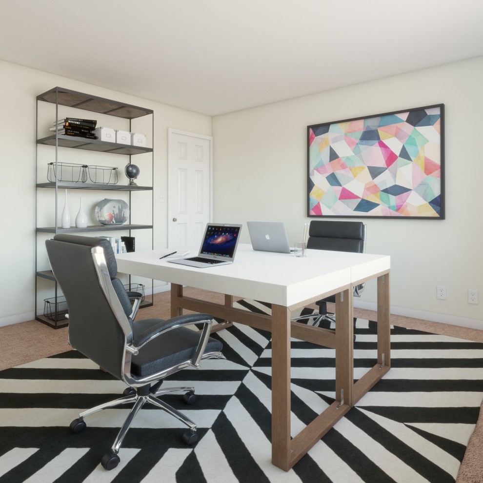 This is an example of a mid-sized contemporary study room in Richmond with beige walls, carpet, no fireplace, a freestanding desk and brown floor.