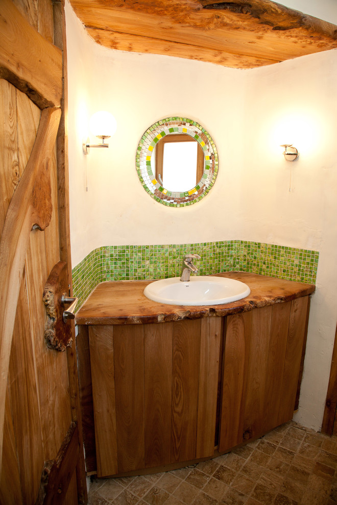 Eclectic powder room in Other with mosaic tile, wood benchtops and green tile.