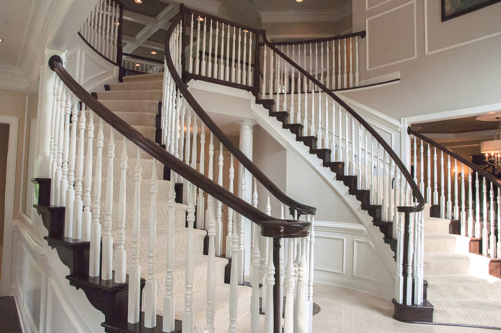This is an example of a large traditional wood curved staircase in DC Metro with wood risers.