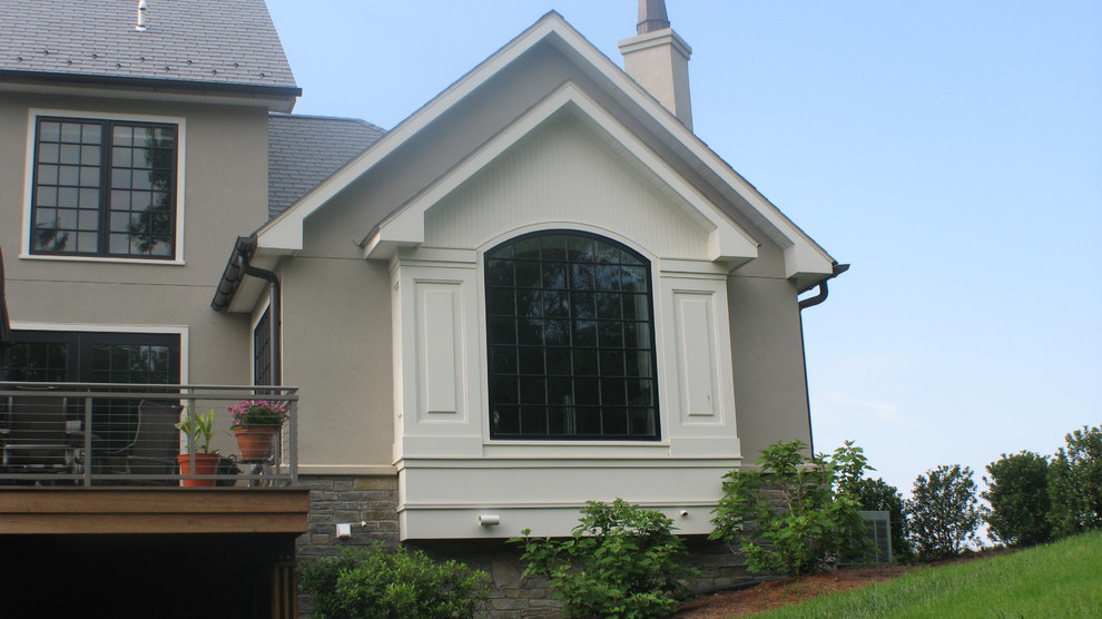 Design ideas for a large traditional two-storey grey exterior in Other with stone veneer.