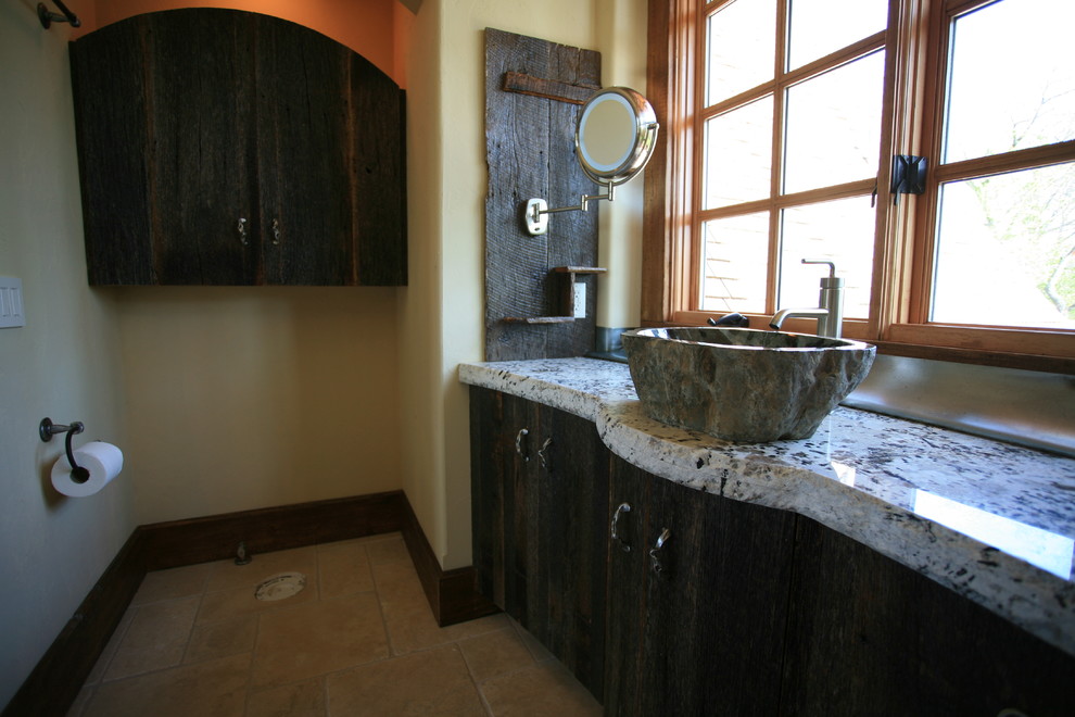 Alcove shower - mid-sized rustic 3/4 porcelain tile and beige floor alcove shower idea with furniture-like cabinets, medium tone wood cabinets, a two-piece toilet, yellow walls, an integrated sink, granite countertops and a hinged shower door