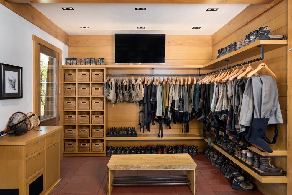 This is an example of a large country storage and wardrobe in Denver with vinyl floors and red floor.