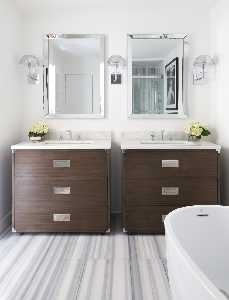 Inspiration for a contemporary bathroom in New York with flat-panel cabinets, medium wood cabinets, a freestanding tub, white walls, an undermount sink, white floor and white benchtops.