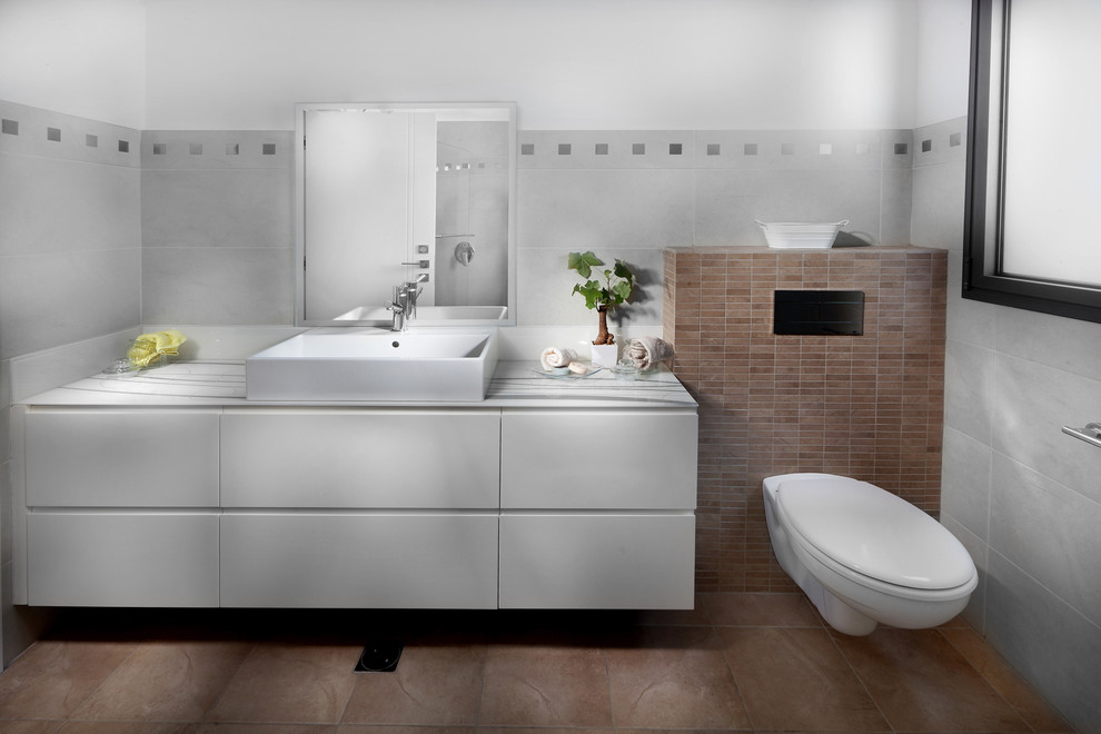 Photo of a modern bathroom in Other with a wall-mount toilet.