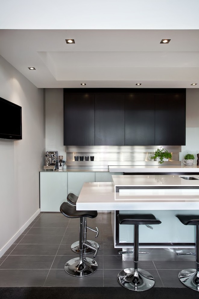 Inspiration for a contemporary kitchen in Dunedin with metallic splashback, metal splashback and with island.