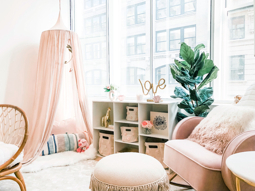 Design ideas for a mid-sized transitional nursery for girls in New York with white walls, bamboo floors and brown floor.