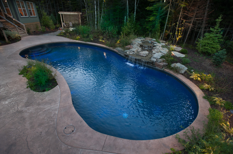 This is an example of an arts and crafts pool in Other with stamped concrete.
