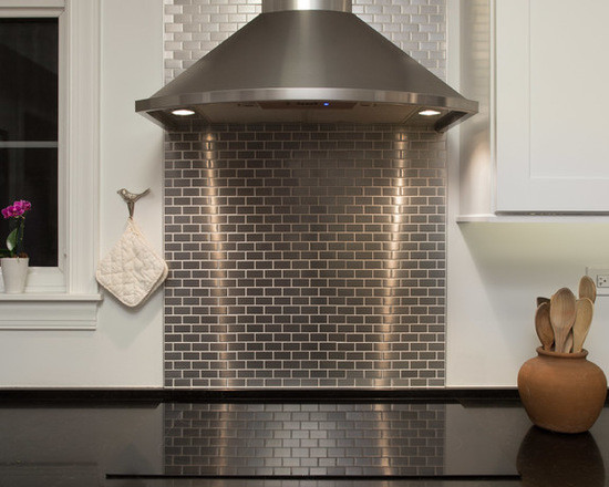Inspiration for a mid-sized transitional u-shaped medium tone wood floor enclosed kitchen remodel in Chicago with a double-bowl sink, shaker cabinets, white cabinets, quartzite countertops, gray backsplash, subway tile backsplash, stainless steel appliances and no island