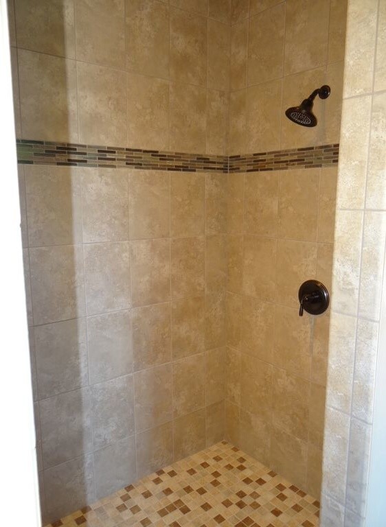 Example of a mid-sized transitional mosaic tile floor corner shower design with beige walls
