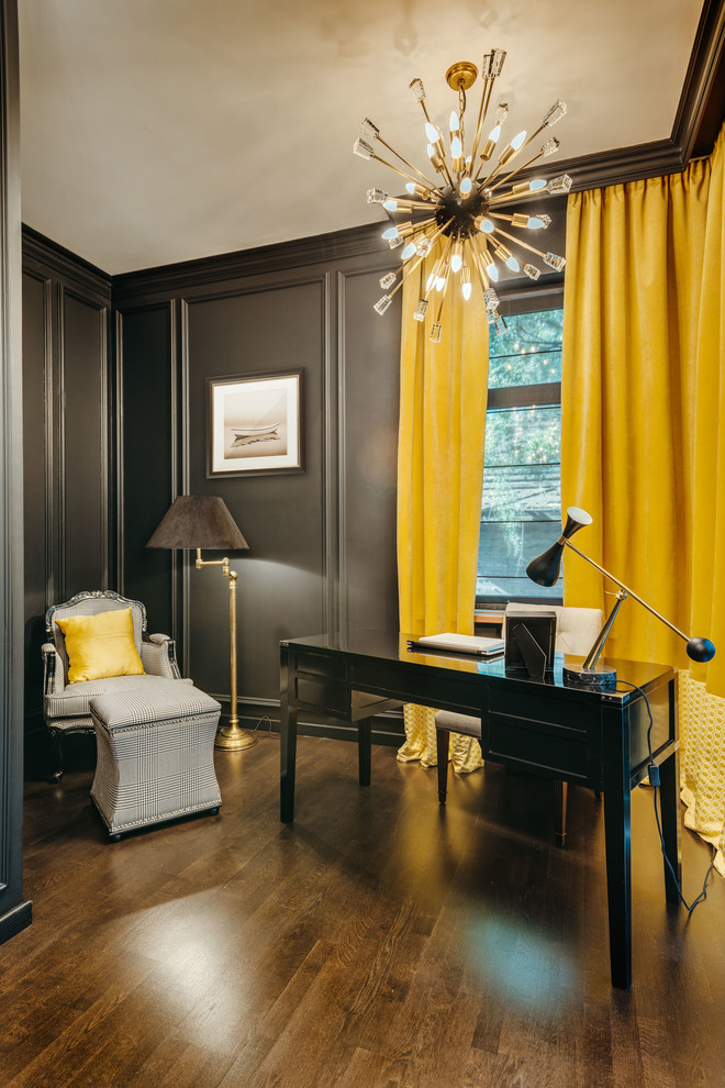 This is an example of a transitional study room in Moscow with black walls, dark hardwood floors, no fireplace, a freestanding desk and brown floor.