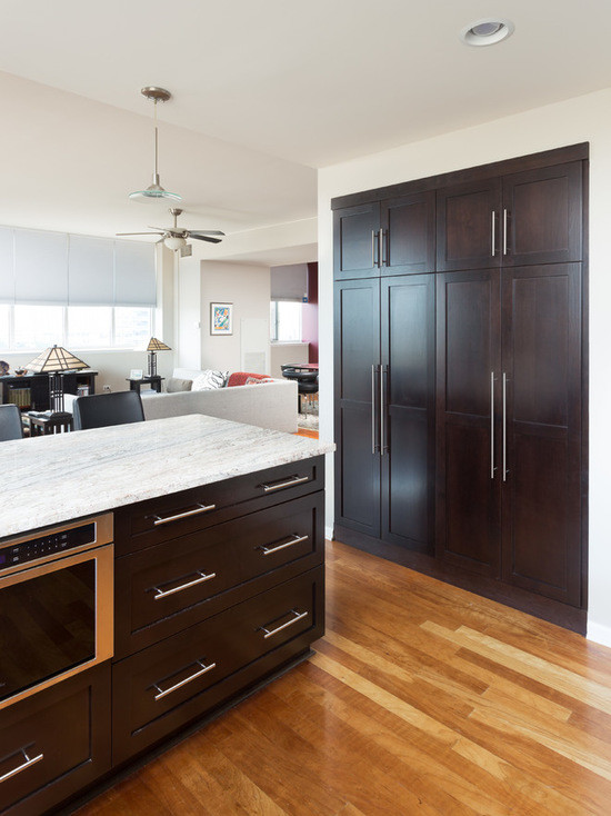 Mid-sized transitional u-shaped medium tone wood floor open concept kitchen photo in Chicago with an undermount sink, shaker cabinets, dark wood cabinets, marble countertops, white backsplash, subway tile backsplash, stainless steel appliances and a peninsula