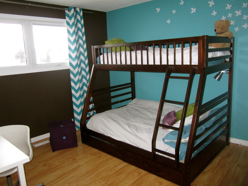 This is an example of a mid-sized contemporary kids' bedroom for kids 4-10 years old and girls in Edmonton with light hardwood floors and multi-coloured walls.