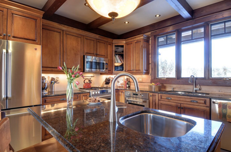 Large mountain style galley dark wood floor open concept kitchen photo in Boston with an undermount sink, shaker cabinets, white cabinets, granite countertops, stainless steel appliances and an island