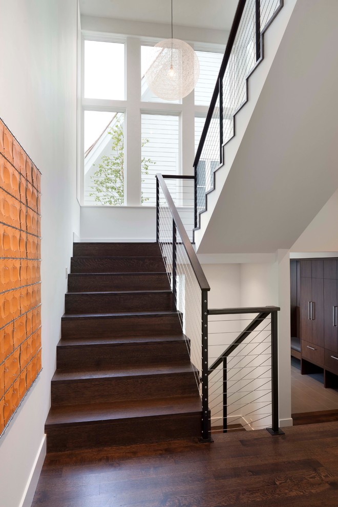 Inspiration for a contemporary wood staircase in Minneapolis with wood risers.