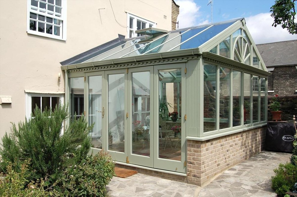 Photo of a small traditional sunroom in Cambridgeshire with brick floors, a glass ceiling and beige floor.